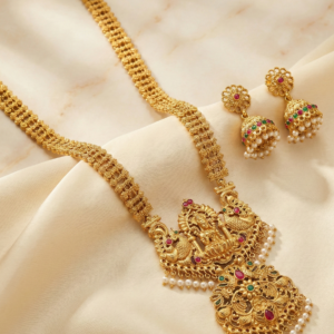 Goddess Lakshmi Long Haram Necklace Set with Jhumka Earrings | Antique Finish Ruby & Emerald Stone Design with Pearl Drops for Women & Brides