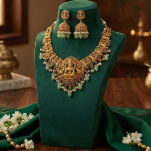 Handcrafted Lakshmi Motif Short Necklace with Matching Jhumka Earrings | Ruby & Emerald Stone Accents with Mint Green Bead Droplets