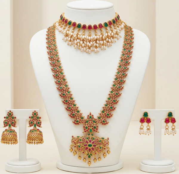 Gold plated bridal jewellery set with long haar, choker and earrings in ruby red and emerald green