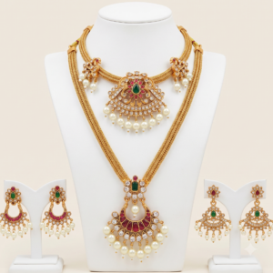 South Indian matte gold long and short necklace set with ruby green stones, pearl drops and two pairs of earrings