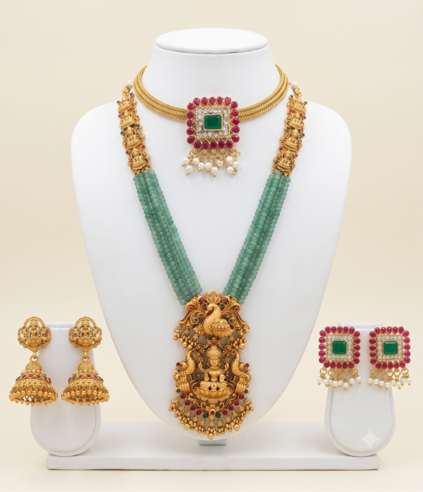 South Indian matte gold Lakshmi green beads long haram and ruby green choker combo with two pairs of earrings