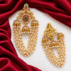 Front and back view of South Indian peacock jhumka hair ornament showing layered pearl chains and rear clip attachment.