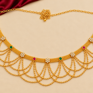 Traditional gold finish Kamarpatta waist belt with ruby-red, emerald-green and white floral stones, mesh band and cascading gold-tone bead chains.