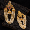 Front and back view of South Indian peacock jhumka hair bun accessory with ruby green stones, pearl chains and rear hair clip.