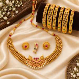 Flatlay photo of gold plated Maharashtrian thushi choker necklace with ruby and pearl crescent pendant, clip-on nath, floral stud earrings, and 6 mesh bangles on ivory satin fabric.